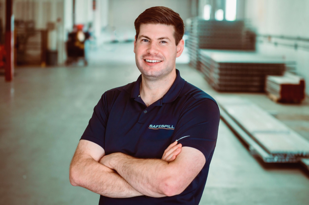 Kyle standing in warehouse.