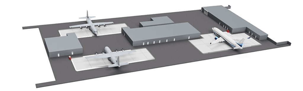 Three airplanes parked on a tarmac near rectangular hangars.