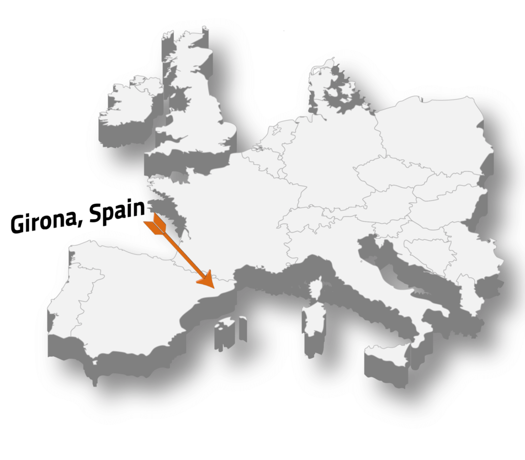 Map highlighting Girona, Spain with an orange arrow.