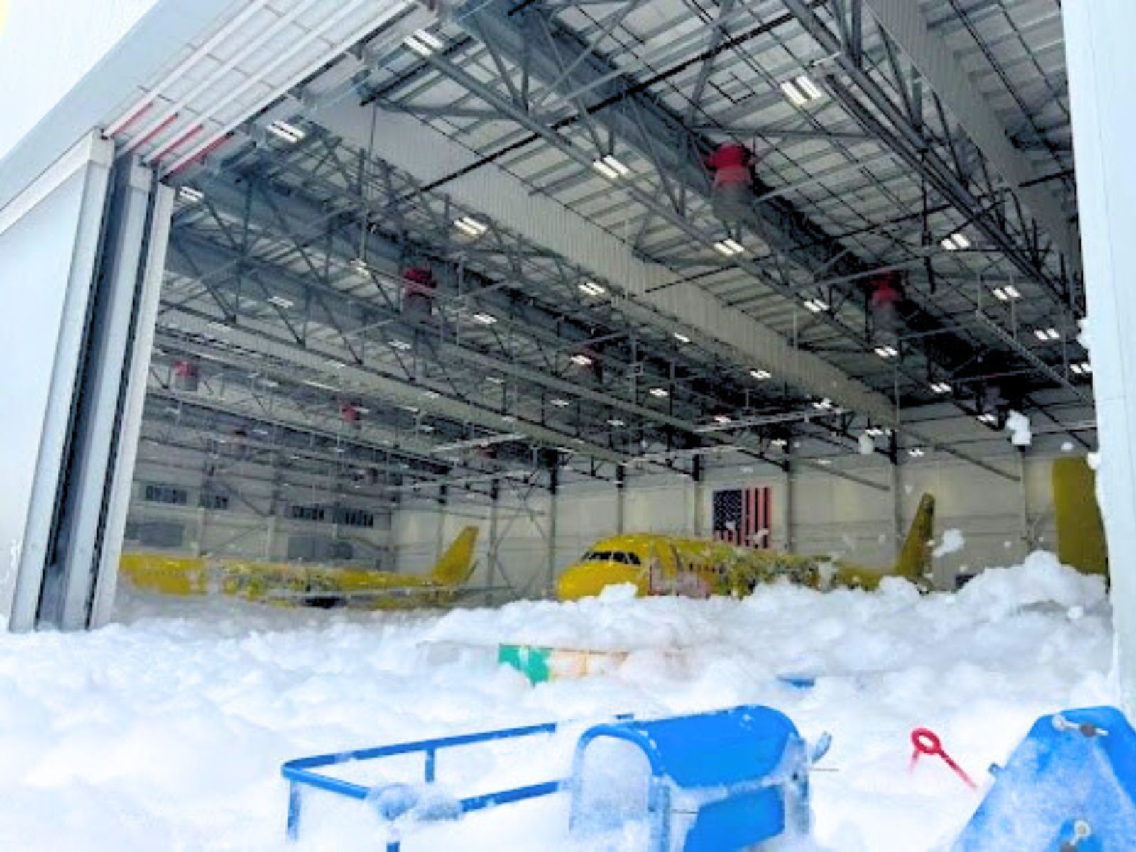 Aircraft in hangar covered by accidental AFF foam discharge.