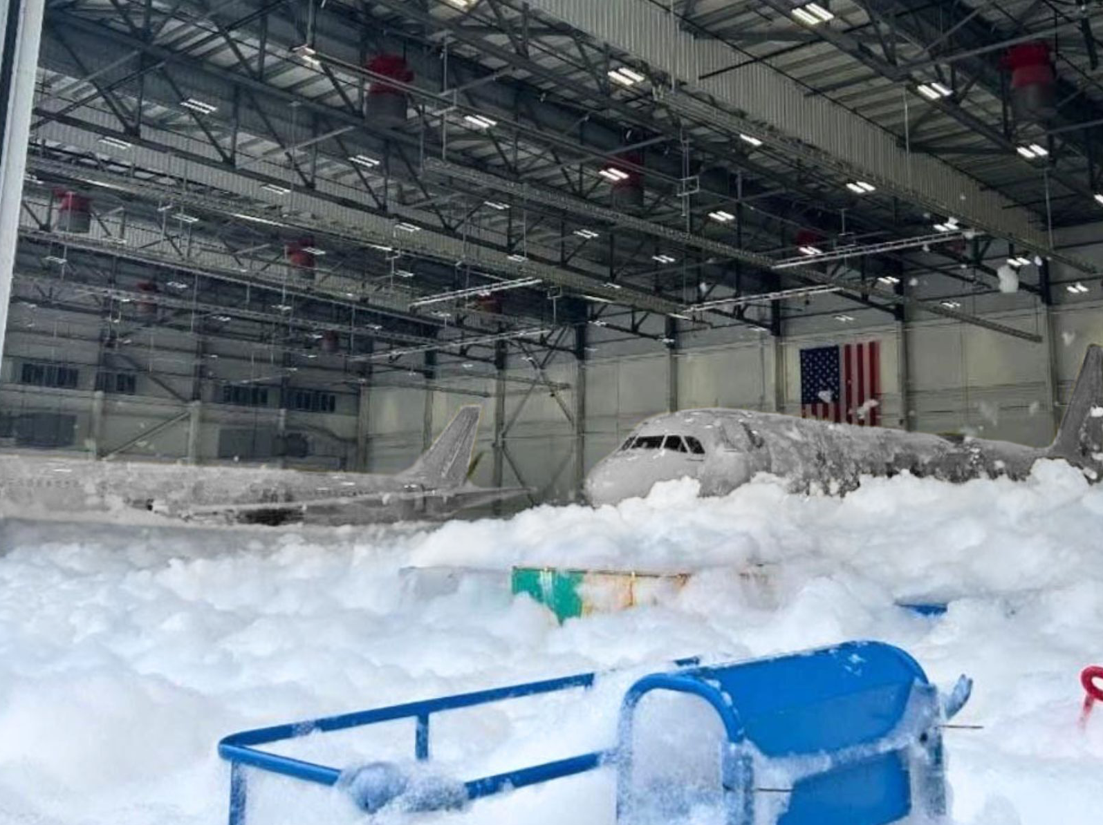 White commercial airline planes covered in Hi Ex Foam from accidental discharge.
