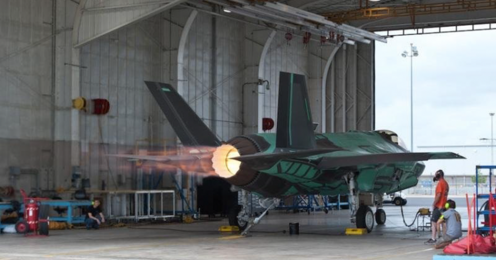 Jet engine warm up inside hangar.
